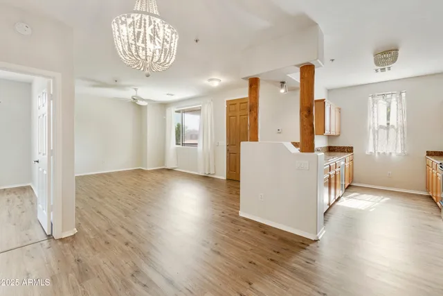 a view of a kitchen with wooden floor and a large window