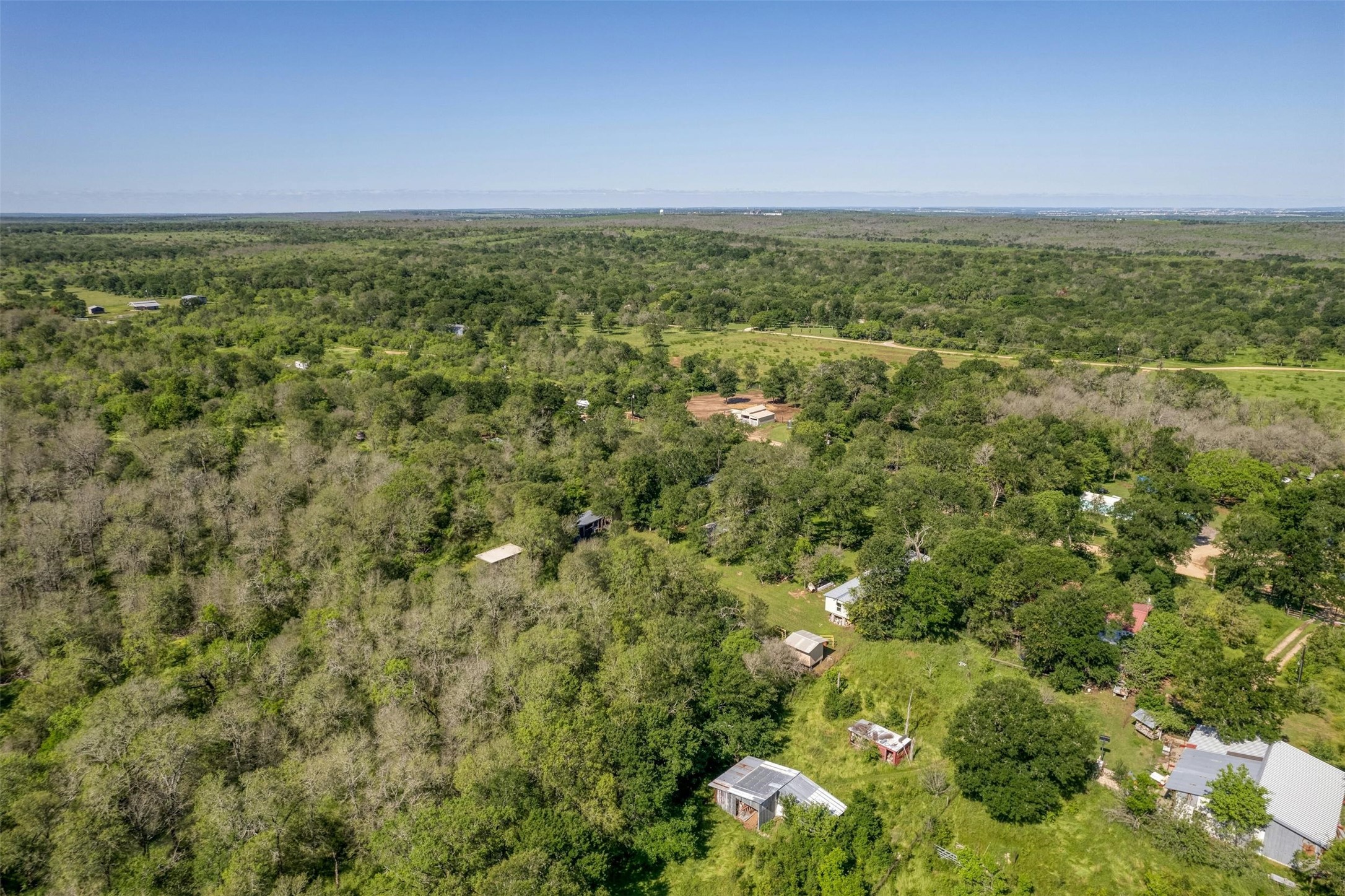201 Fawn Ridge Road Cedar Creek, TX 78612 - Photo 11 of 21 a view of a green field with lots of bushes