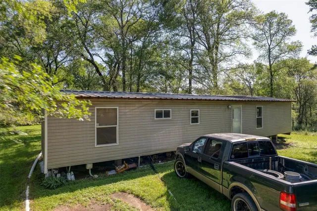 a backyard of a house with yard and outdoor seating