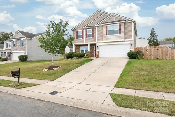 a view of a yard in front view of a house