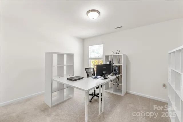 a view of a workspace with furniture