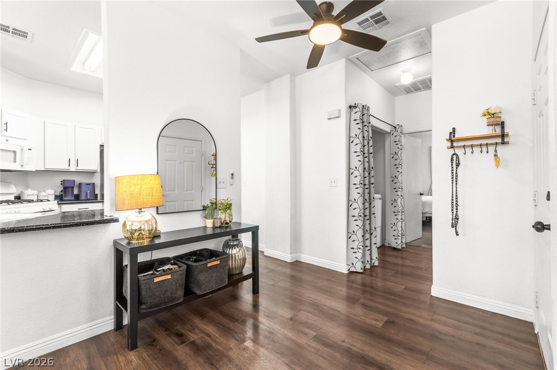 7353 Ridge Star Court Las Vegas, NV 89131 - Photo 14 of 36 Rich hardwood-style flooring extends from the inviting entryway into an open concept living space.