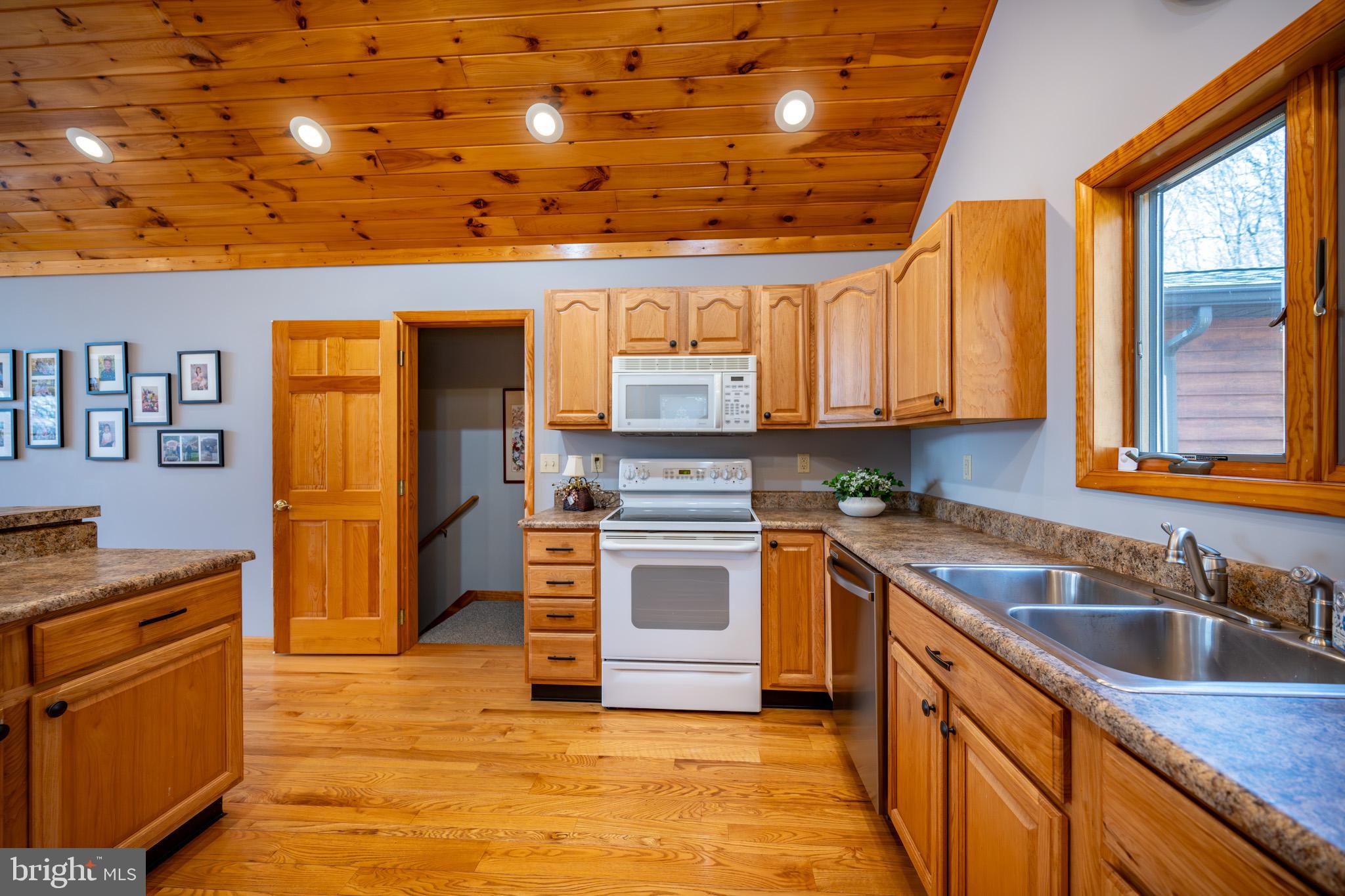 167 Sears Lane Swanton, MD 21561 - Photo 12 of 48 a kitchen with stainless steel appliances granite countertop a stove sink and cabinets