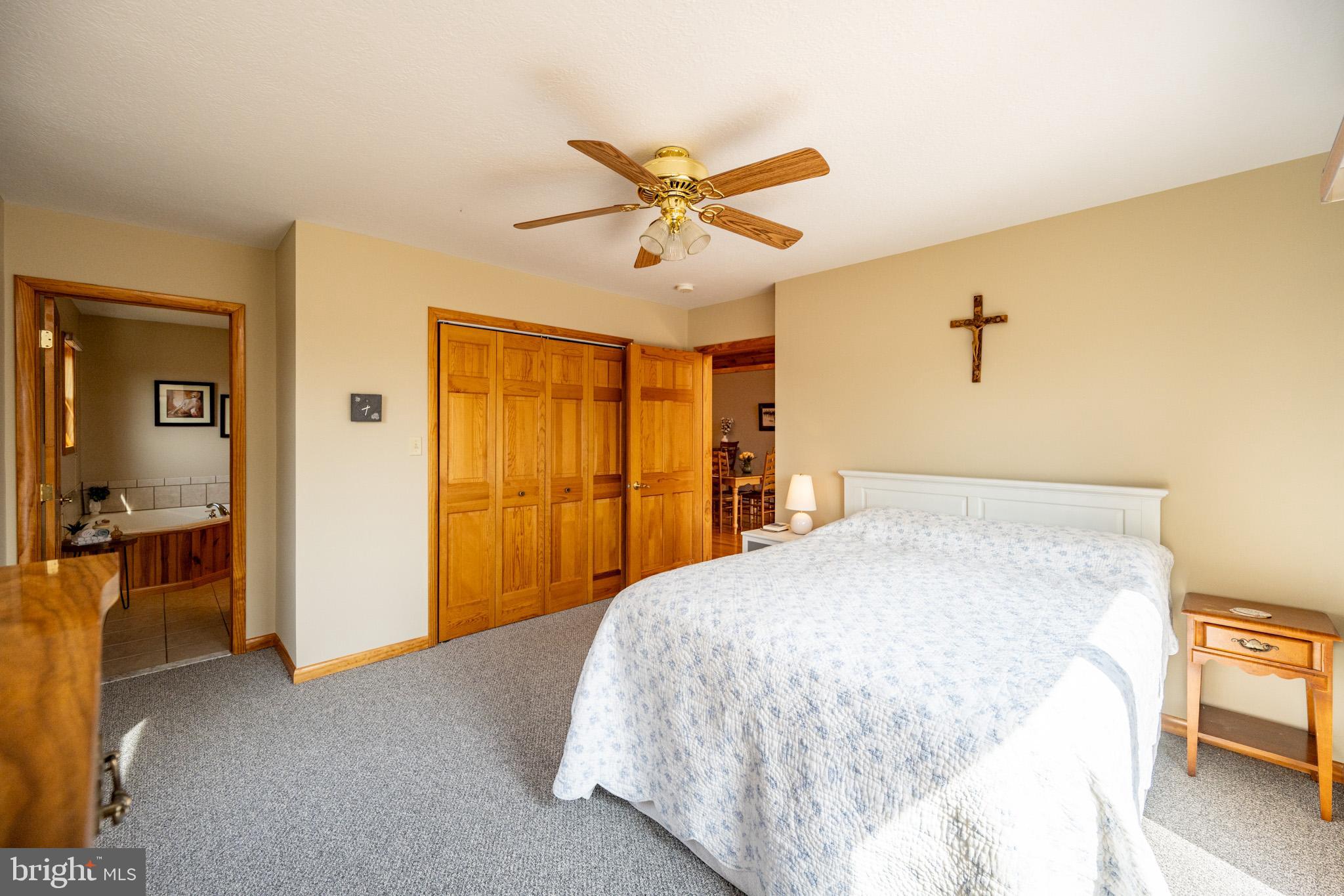 167 Sears Lane Swanton, MD 21561 - Photo 19 of 48 a bedroom with a bed and a chandelier