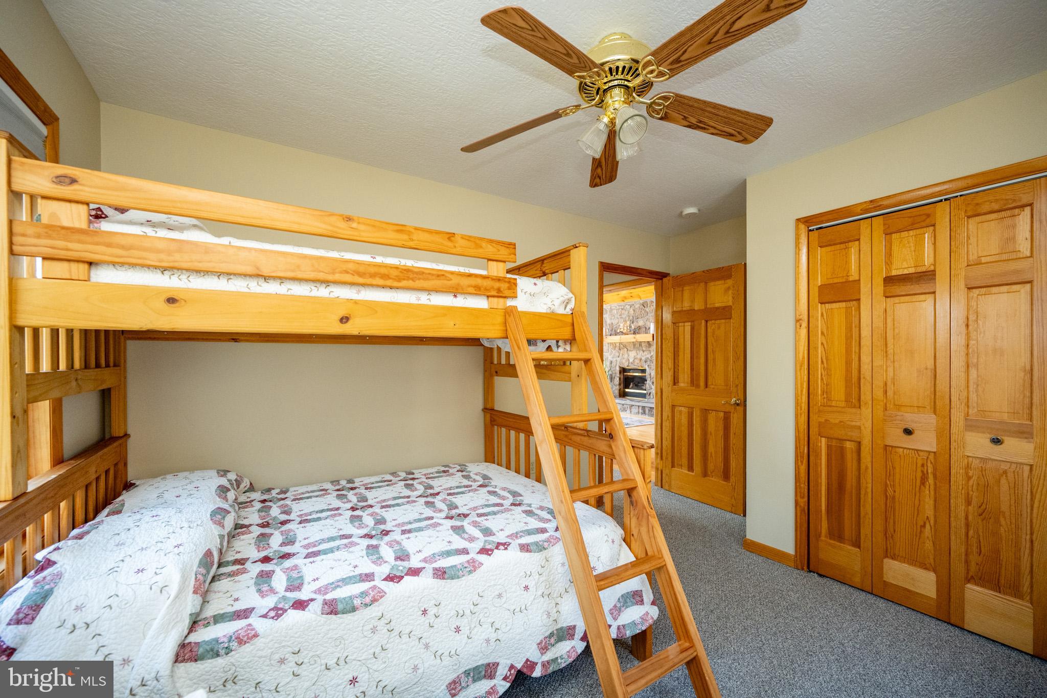 167 Sears Lane Swanton, MD 21561 - Photo 30 of 48 a bedroom with a bed and a chandelier