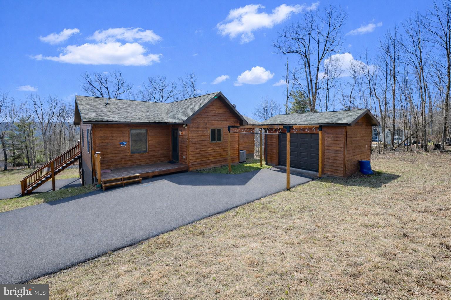 167 Sears Lane Swanton, MD 21561 - Photo 3 of 48 a front view of a house with a yard and garage