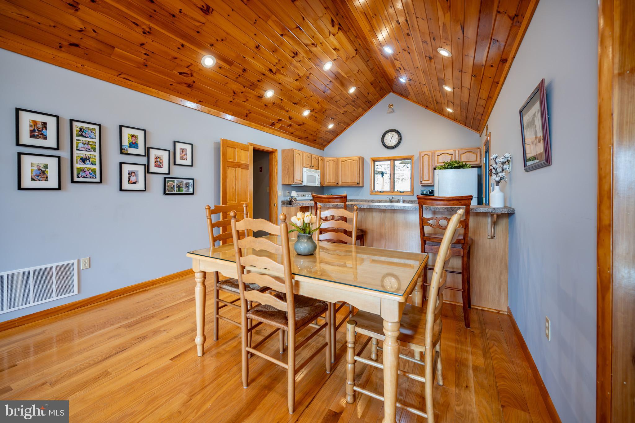167 Sears Lane Swanton, MD 21561 - Photo 9 of 48 a view of a dining room with furniture a chandelier and wooden floor