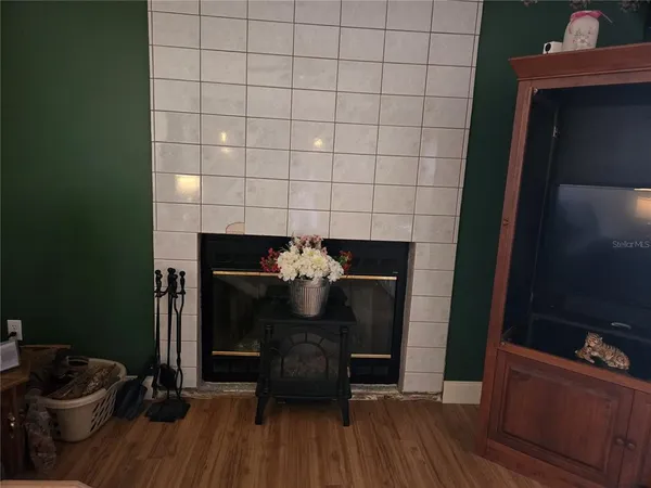 a kitchen with a sink and wooden floor
