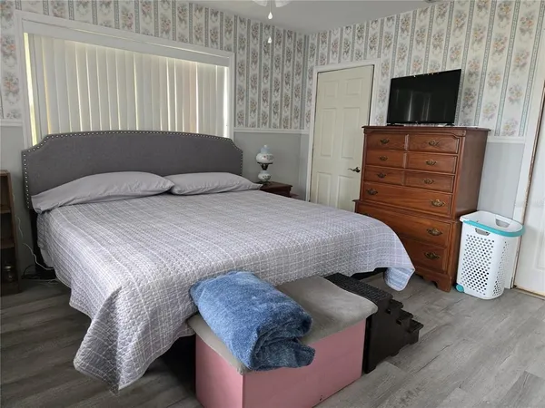 a bedroom with a bed and couch