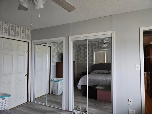 a bedroom with a walk in closet and chandelier