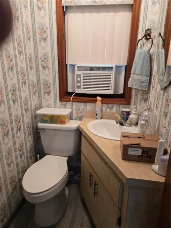 a bathroom with a sink a toilet a mirror and shower curtain
