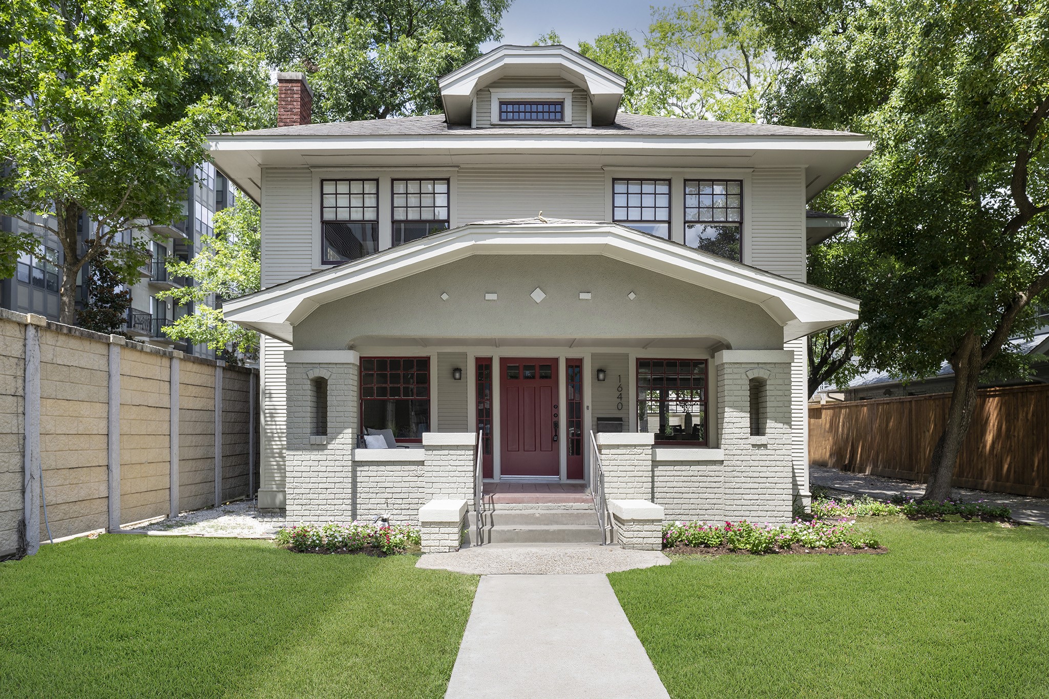 a front view of a house with a garden and yard