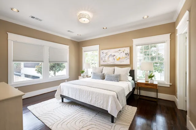 a bedroom with a large bed and a large window