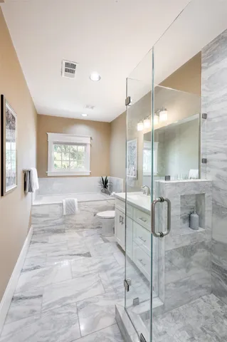 a large bedroom with a large window and furniture