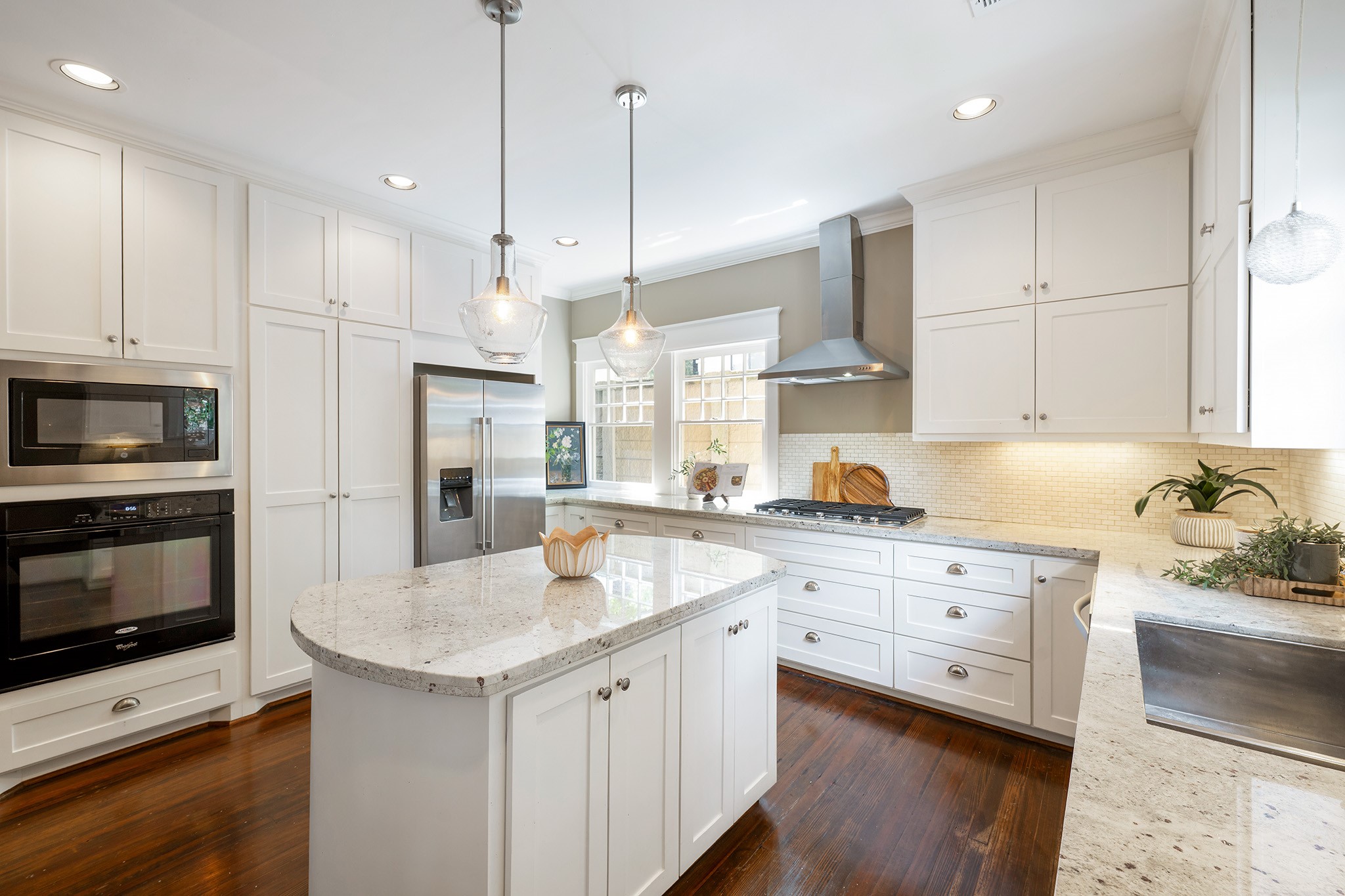 1640 Sul Ross Street Houston, TX 77006 - Photo 7 of 35 a kitchen with stainless steel appliances granite countertop a sink stove a refrigerator and white cabinets with wooden floor