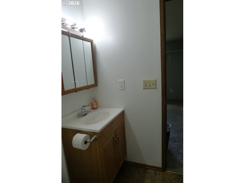412 Camellia Court Reedsport, OR 97467 - Photo 27 of 48 a bathroom with a sink and a mirror