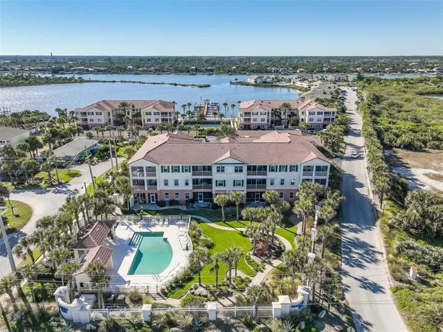 a bed room with a bed and a view of kitchen