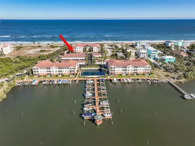 a living room with lots of furniture and kitchen view