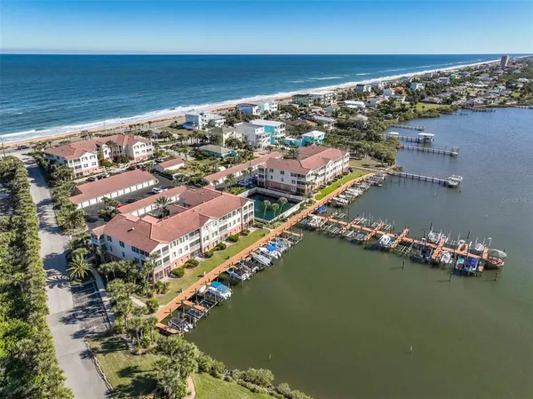 a kitchen with stainless steel appliances kitchen island granite countertop a refrigerator and a dining table