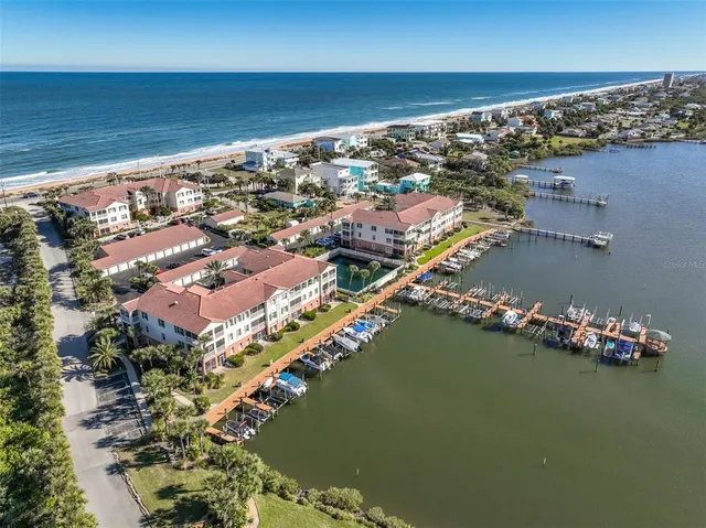 a kitchen with stainless steel appliances kitchen island granite countertop a refrigerator and a dining table