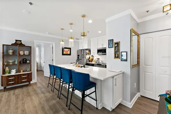 a view of a kitchen with furniture and wooden floor
