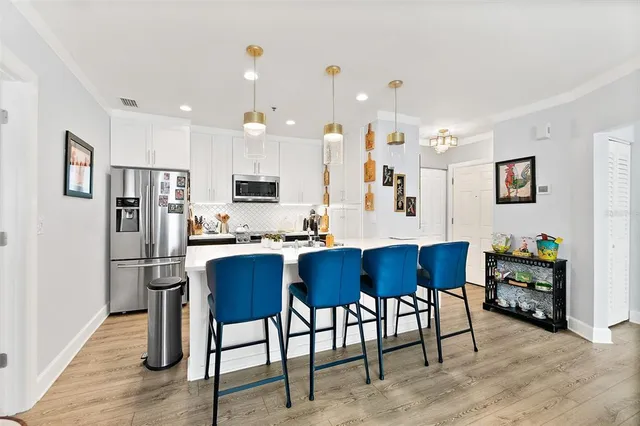 a kitchen with sink cabinets and living room