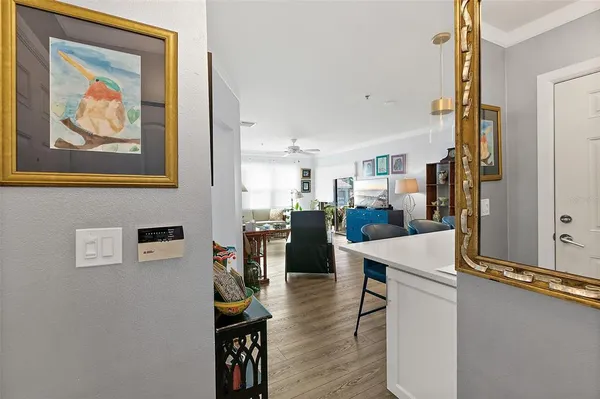 a view of a balcony with chairs and potted plants