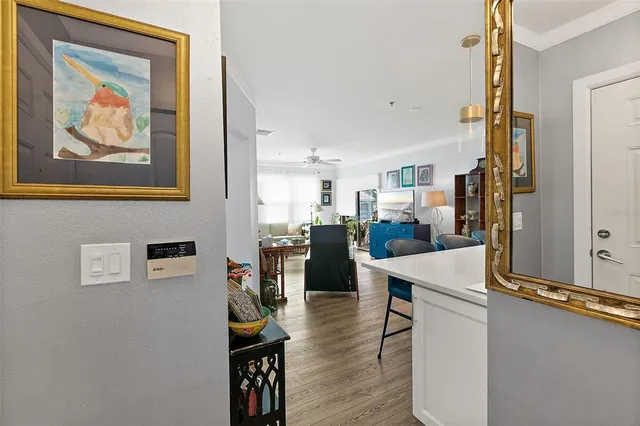 a view of a balcony with chairs and potted plants