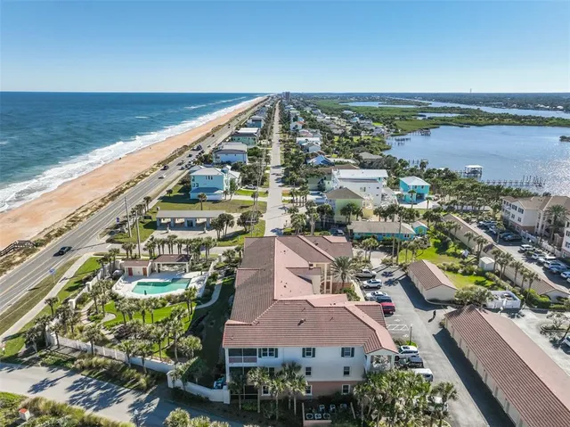 an aerial view of a house with a garden and lake view