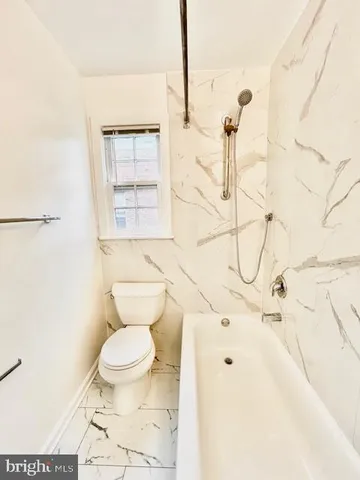 a white toilet sitting next to a bathroom sink