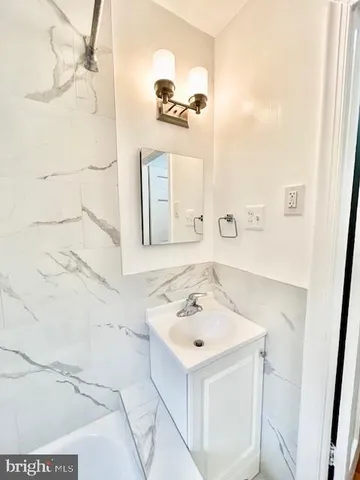 a bathroom with a sink a mirror and shower