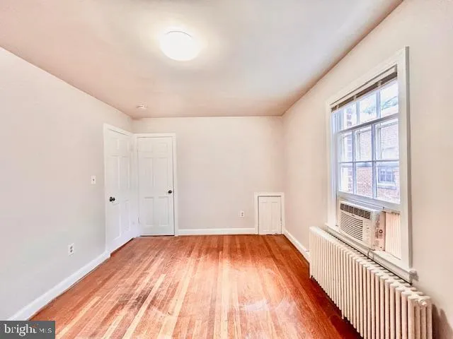a view of a room with wooden floor and windows