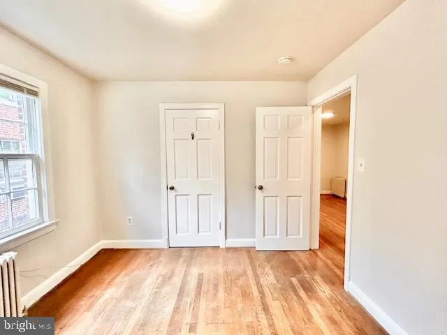 an empty room with windows and closet