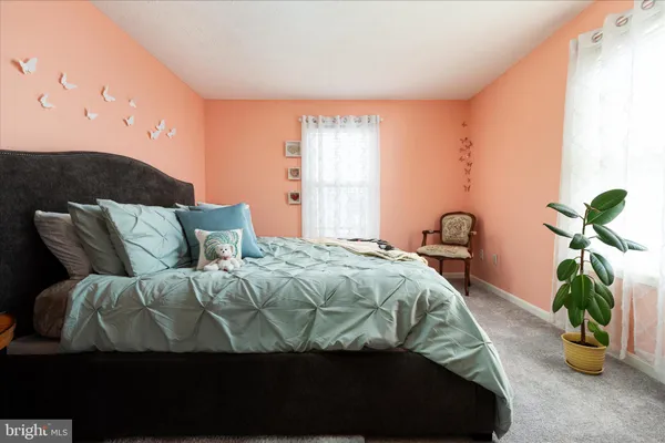 a bedroom with a bed and a potted plant