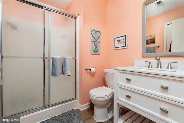 a bathroom with a toilet a sink and shower