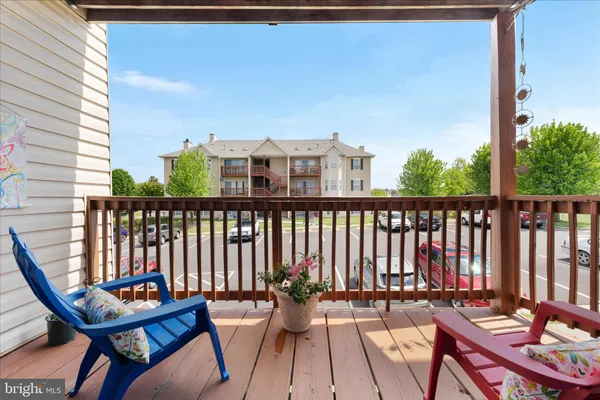 a view of a chairs and table in the balcony