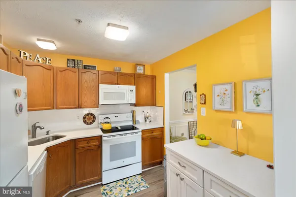 a view of a kitchen with a sink and cabinets