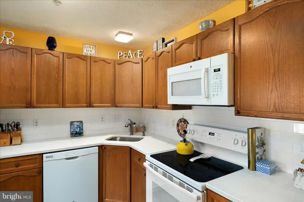 a kitchen with a sink a stove and cabinets