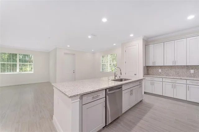 a kitchen with a sink stove and cabinets