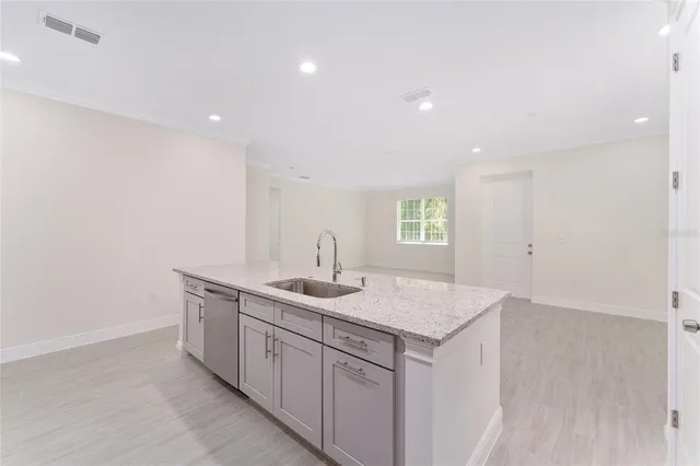 a kitchen with a sink vanity and mirror