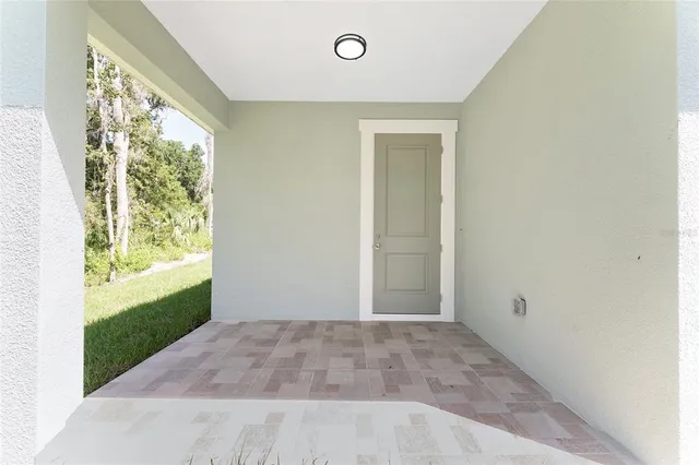a view of porch with a floor to ceiling window and a yard