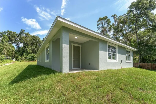 a front view of house with yard and trees