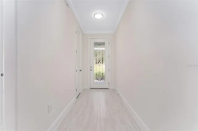 a view of a hallway with wooden floor