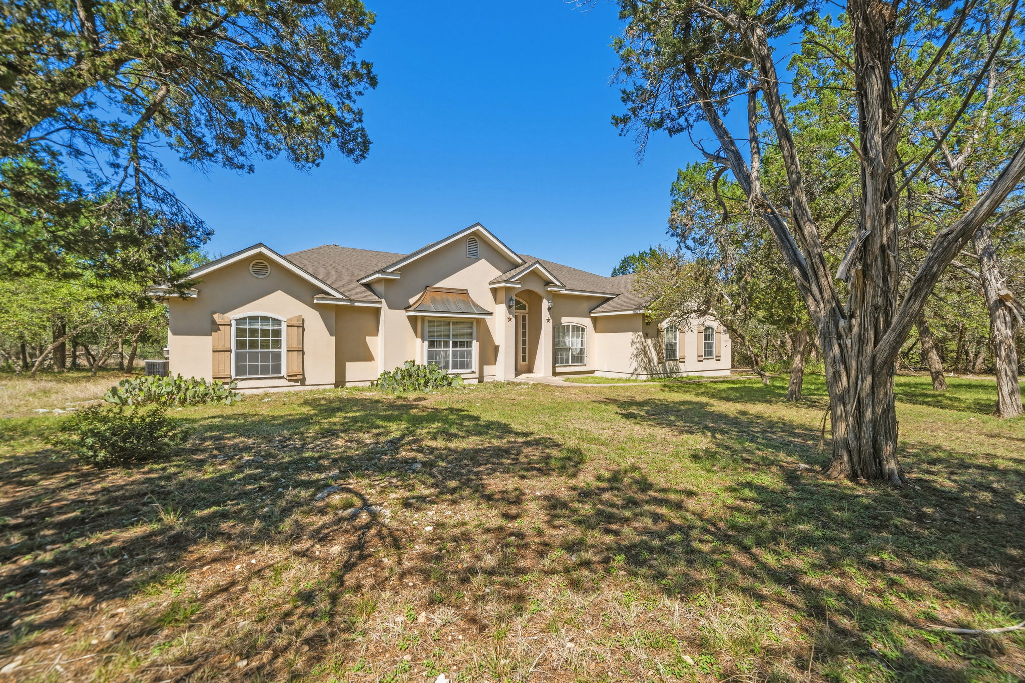 14039 Timberline Trail Austin, TX 78737 - Photo 2 of 39 Single story home with stucco siding and a front yard