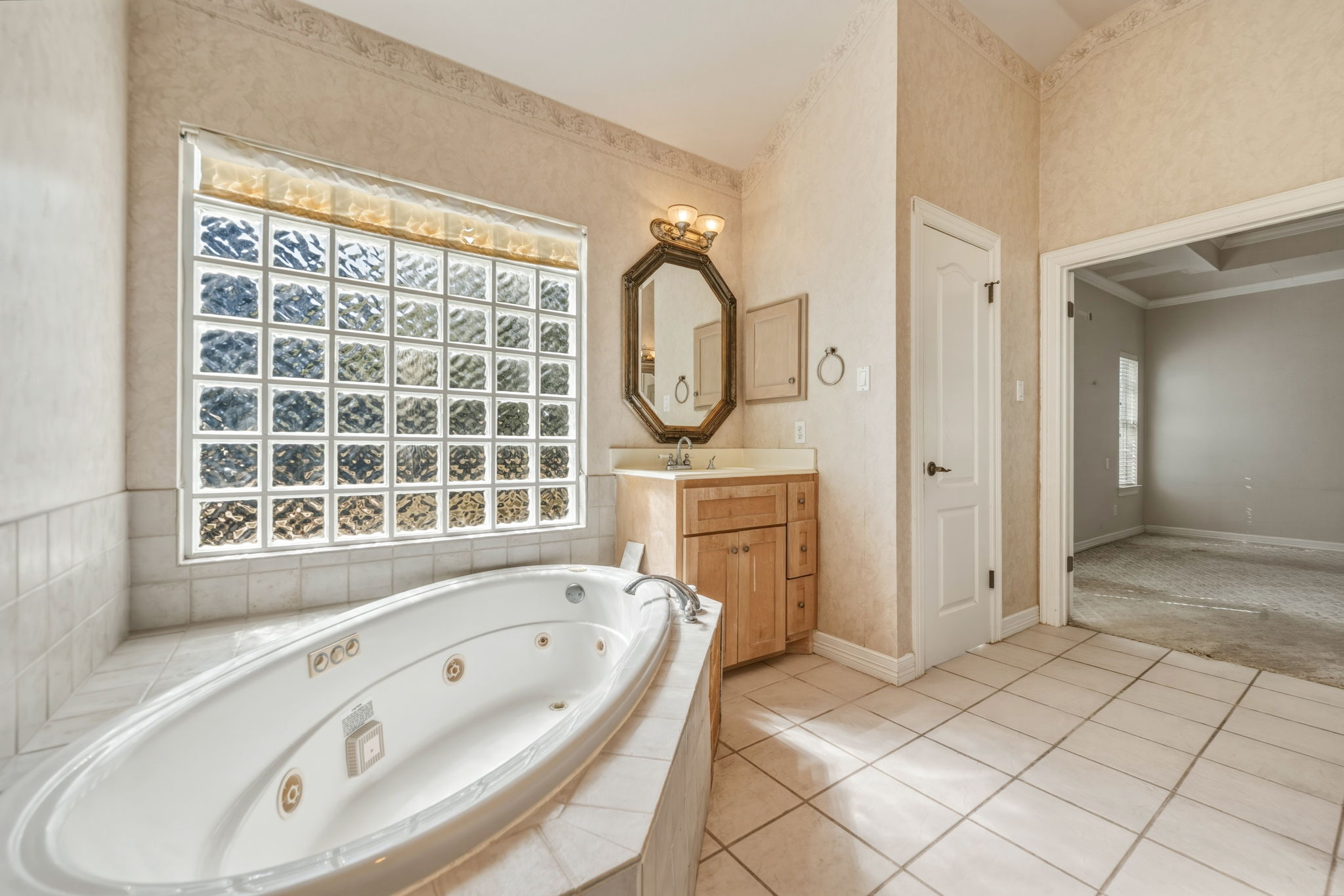 14039 Timberline Trail Austin, TX 78737 - Photo 26 of 39 Bathroom with vanity, a jetted tub, plenty of natural light, and light tile patterned floors