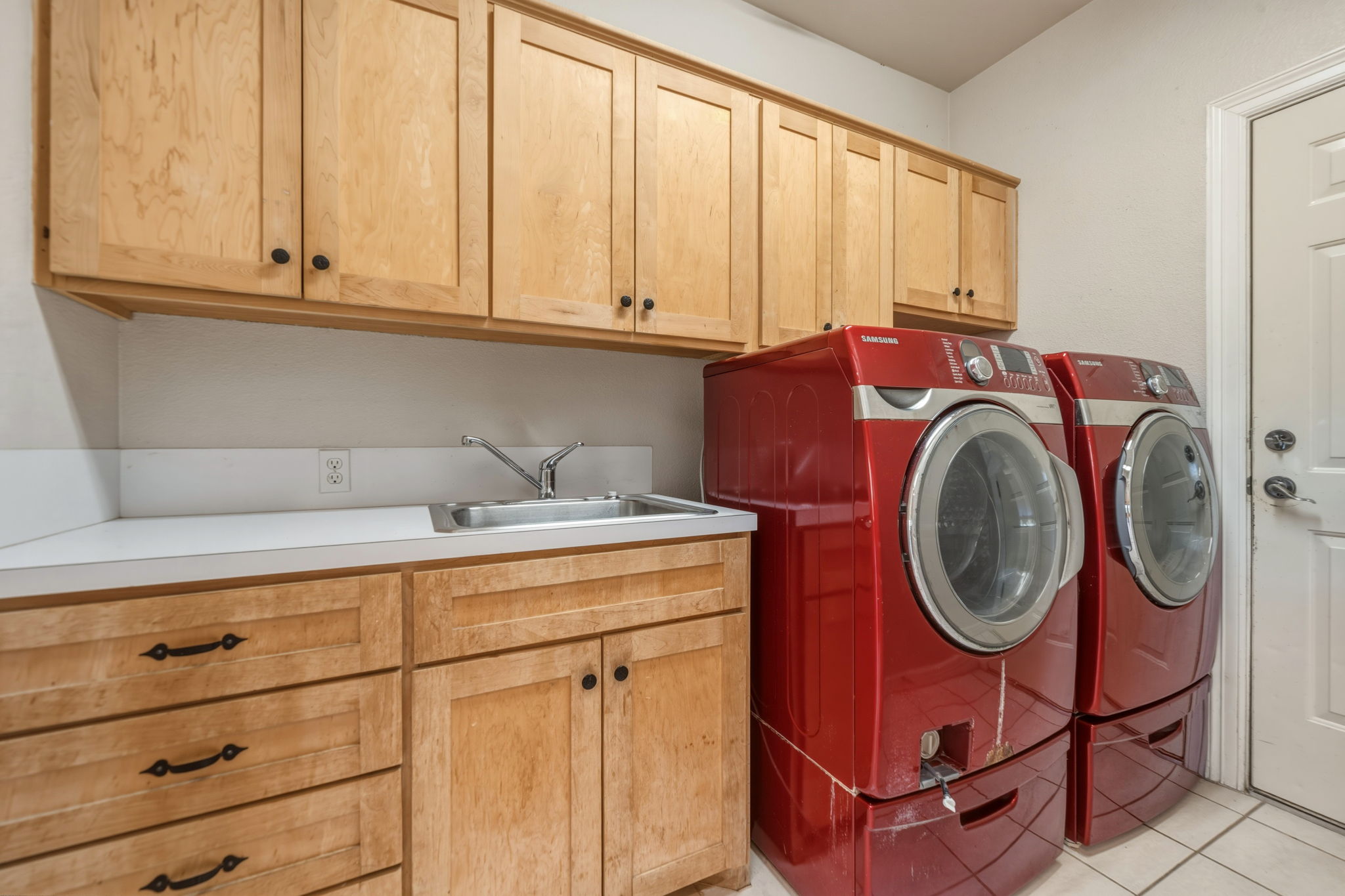 14039 Timberline Trail Austin, TX 78737 - Photo 28 of 39 Laundry room with washer and dryer, cabinet space, and light tile patterned floors