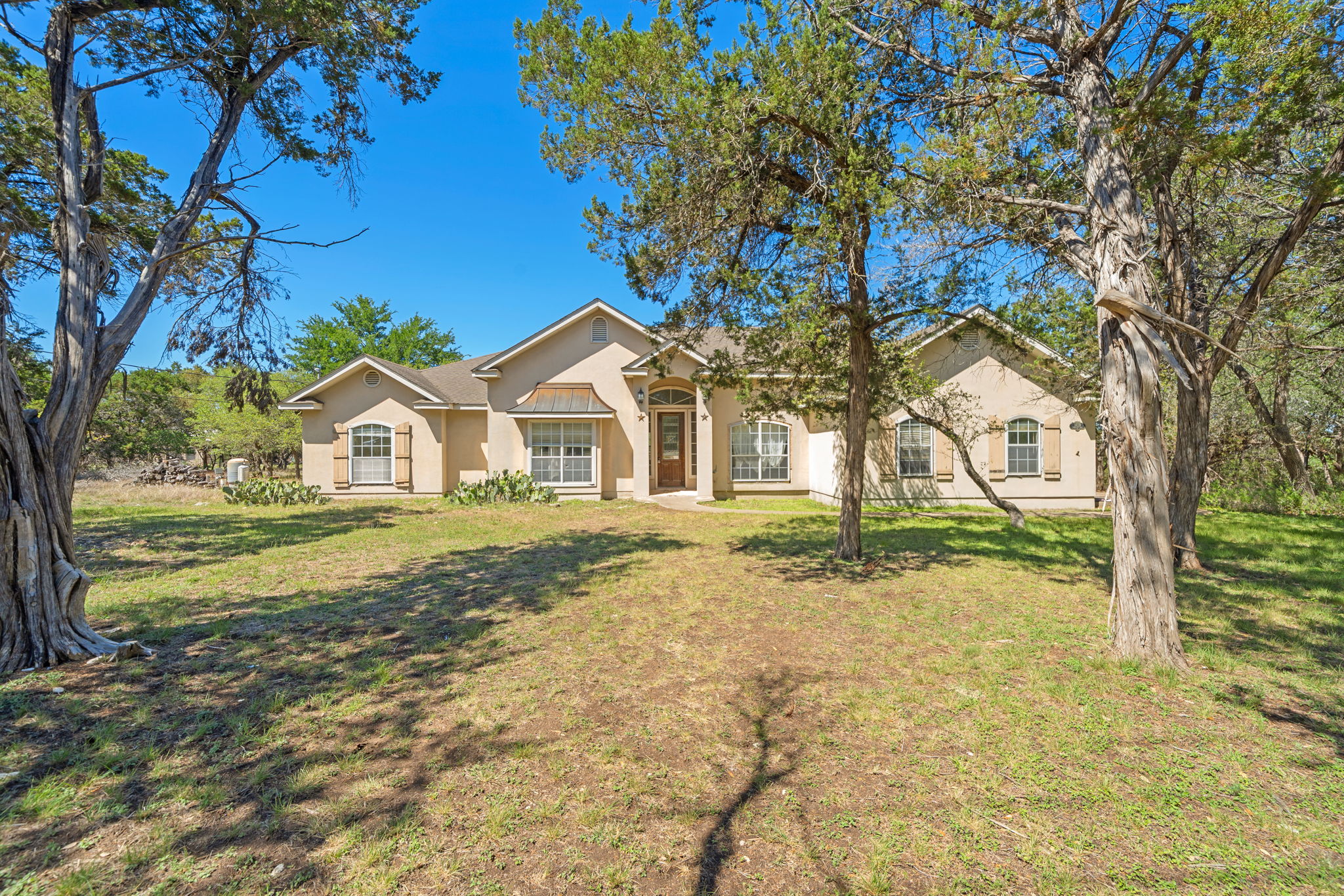 14039 Timberline Trail Austin, TX 78737 - Photo 3 of 39 Ranch-style house with stucco siding and a front yard