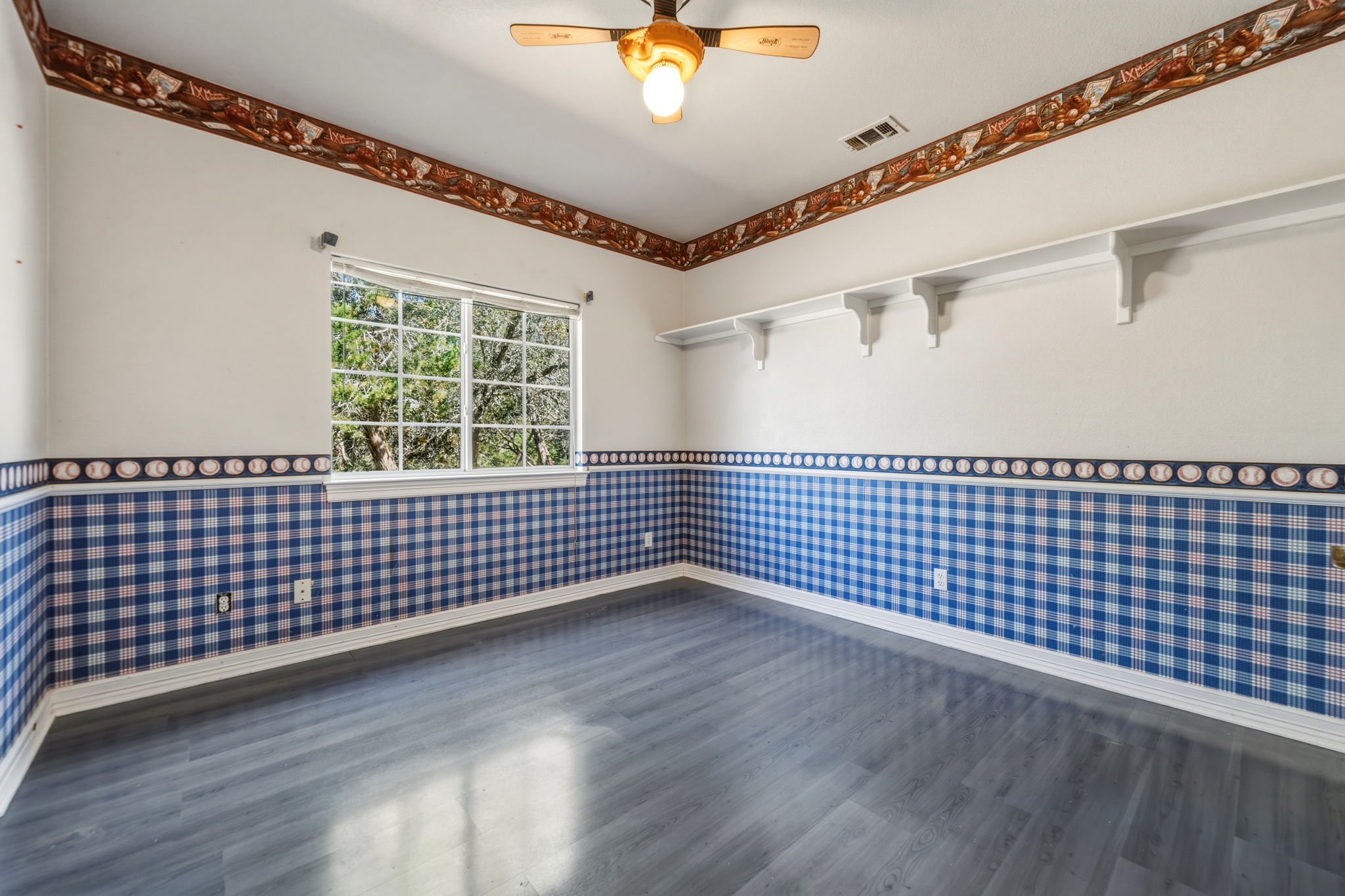 14039 Timberline Trail Austin, TX 78737 - Photo 31 of 39 Unfurnished room with wallpapered walls, a wainscoted wall, ceiling fan, and dark wood-style floors