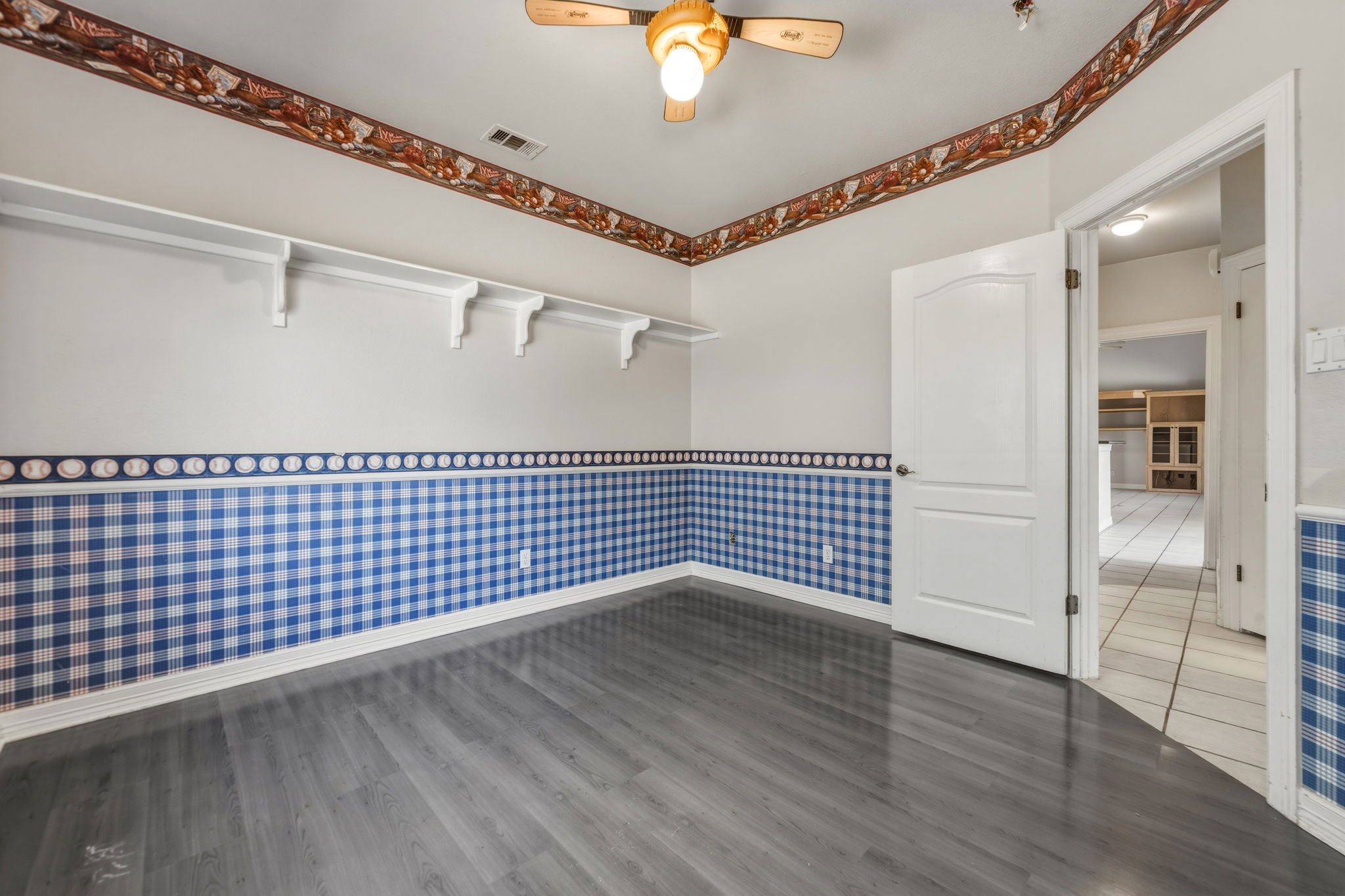 14039 Timberline Trail Austin, TX 78737 - Photo 32 of 39 Spare room with wallpapered walls, ceiling fan, dark wood-style floors, and wainscoting