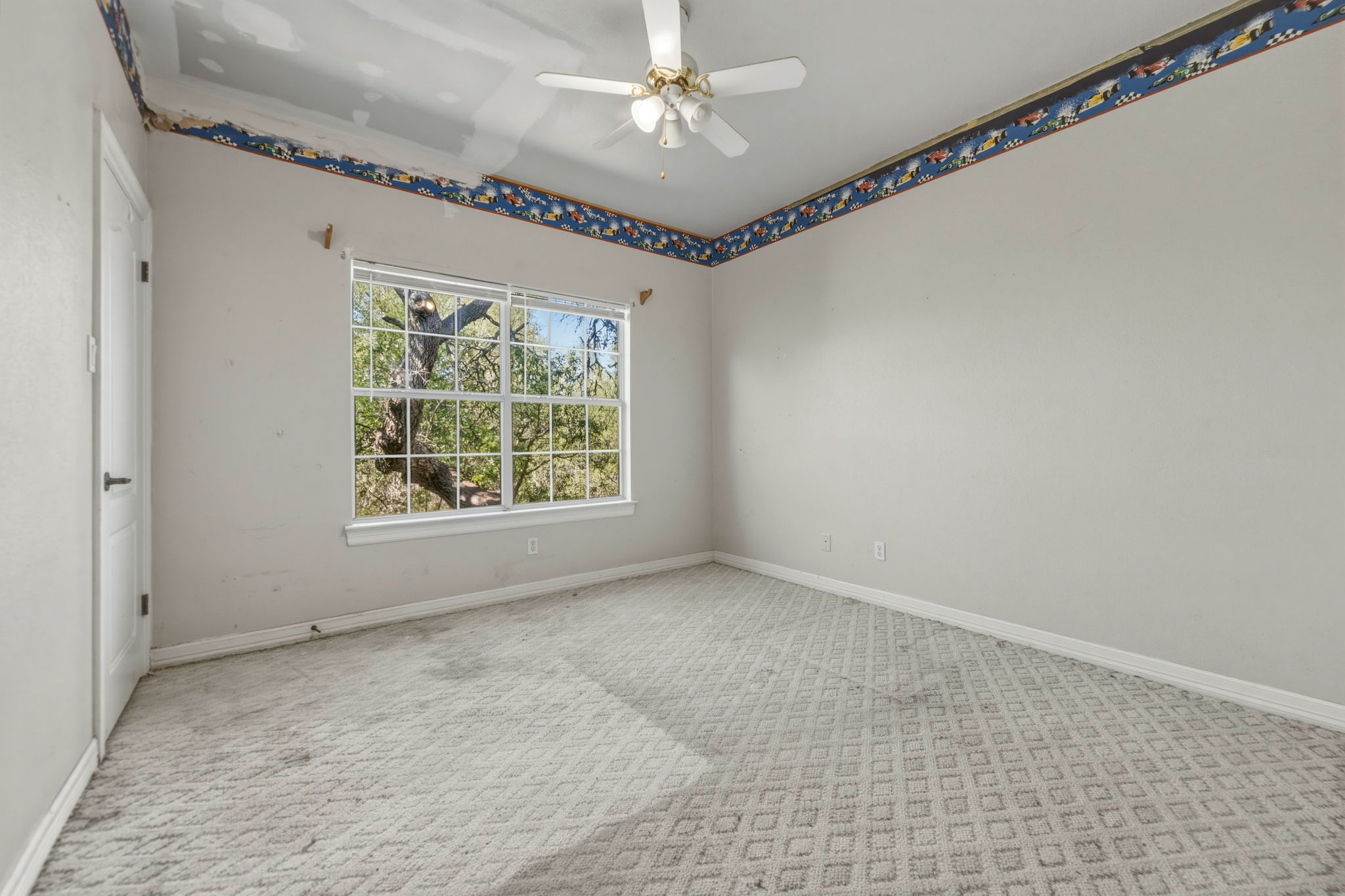 14039 Timberline Trail Austin, TX 78737 - Photo 33 of 39 Carpeted spare room with baseboards and a ceiling fan